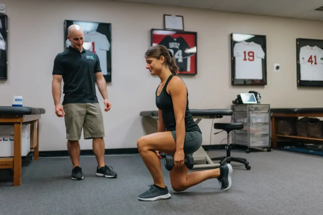 Dr. Dave Tilley coaching an athlete through a dumbbell split squat
