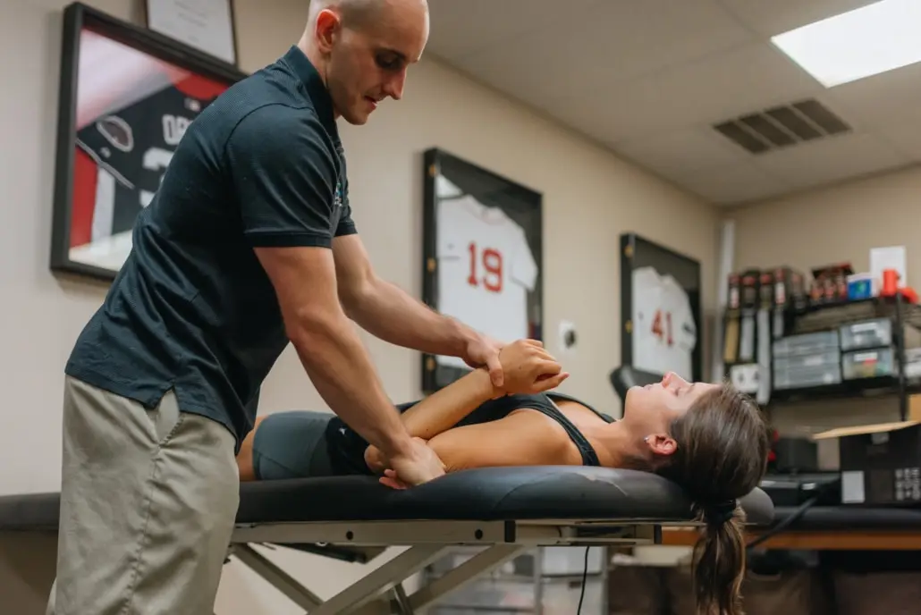 Dr. Dave Tilley performing a shoulder assessment on a patient